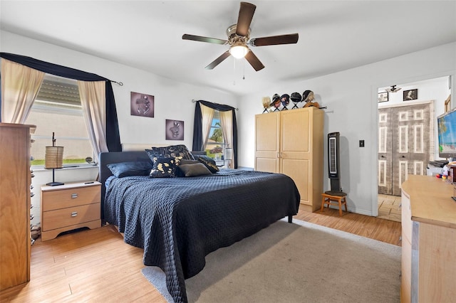 bedroom featuring light wood-type flooring and ceiling fan