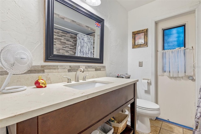 bathroom featuring tile patterned floors, curtained shower, vanity, and toilet