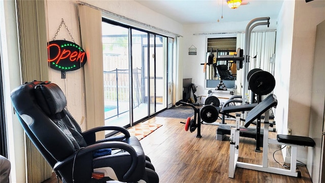 workout area with hardwood / wood-style floors