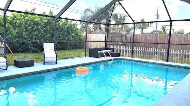 view of pool with glass enclosure