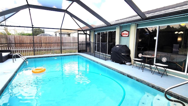 view of swimming pool with a lanai, a patio, and a grill