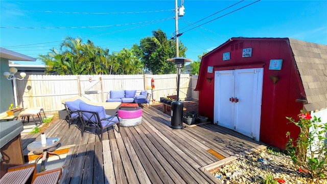 deck with a shed and outdoor lounge area