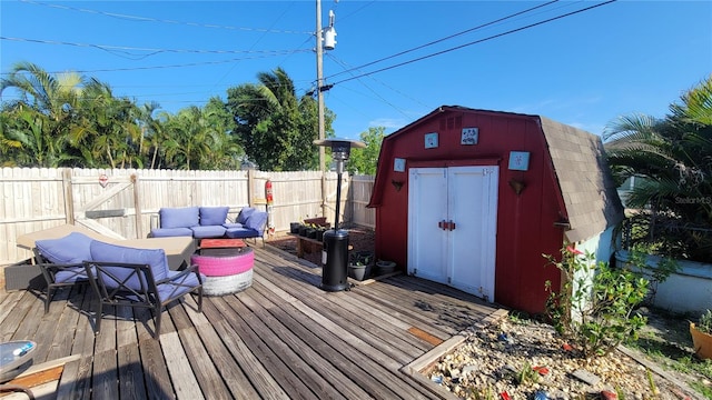 deck featuring an outdoor living space and a storage unit