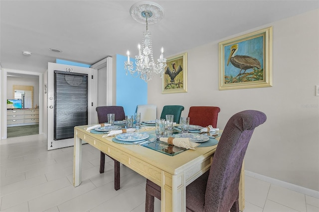 tiled dining area with an inviting chandelier