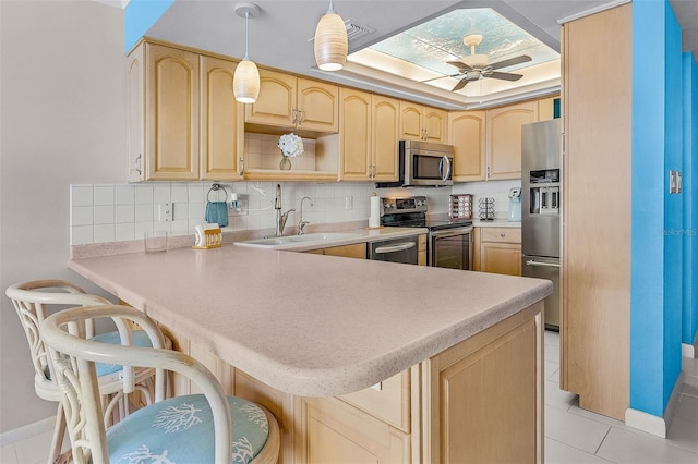 2532 Estero Blvd Unit 607, Fort Myers Beach, FL 33931 - kitchen featuring stainless steel appliances, a peninsula, ceiling fan, and light brown cabinetry