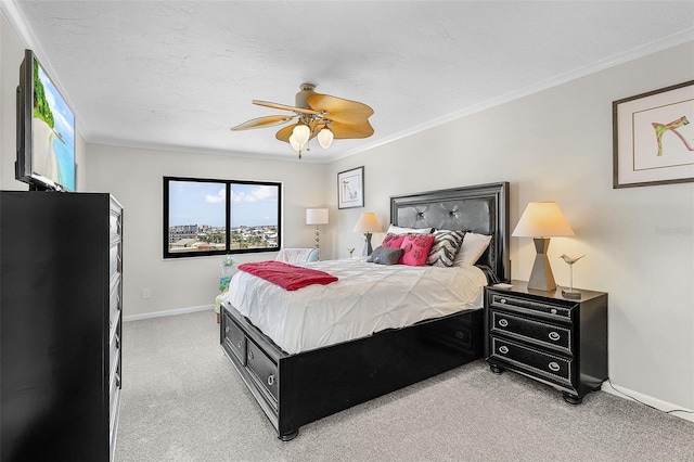 bedroom with ceiling fan, crown molding, a textured ceiling, and light colored carpet