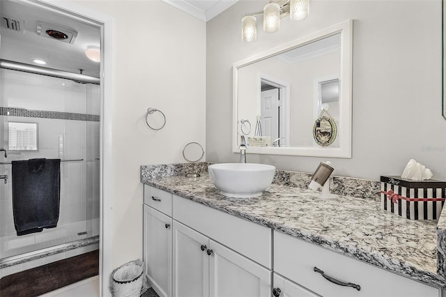 bathroom featuring vanity, walk in shower, and ornamental molding