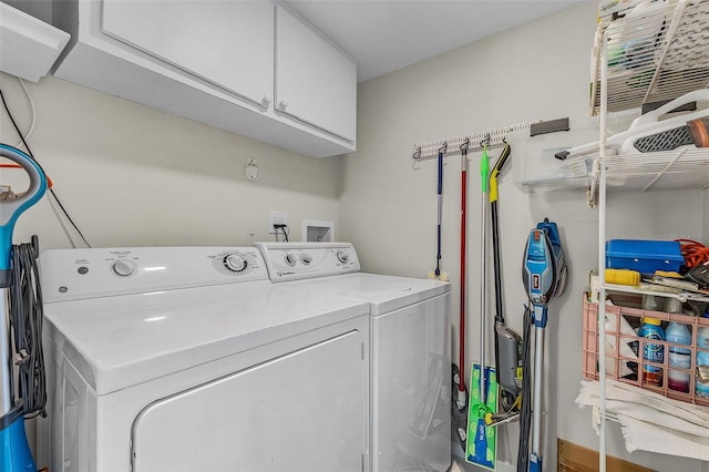 laundry area featuring washer and dryer and cabinets