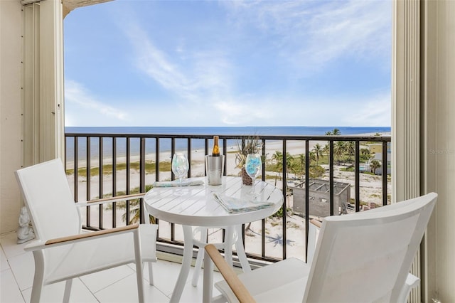 balcony featuring a water view and a view of the beach