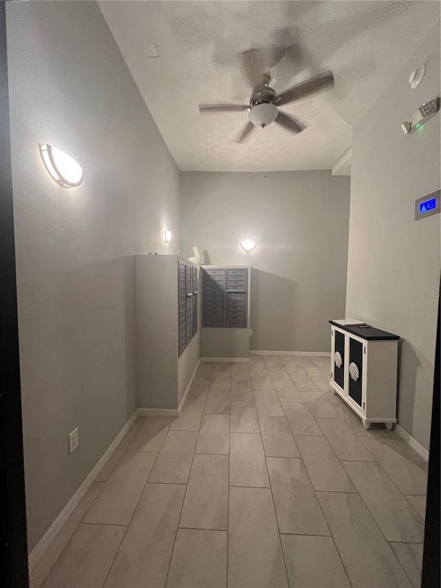 tiled spare room featuring a textured ceiling and ceiling fan