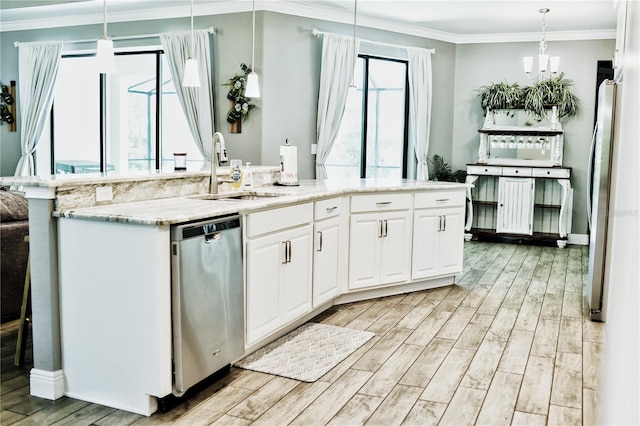 kitchen with pendant lighting, stainless steel appliances, white cabinetry, and light hardwood / wood-style flooring