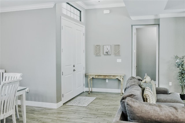 entrance foyer with light wood-type flooring and crown molding