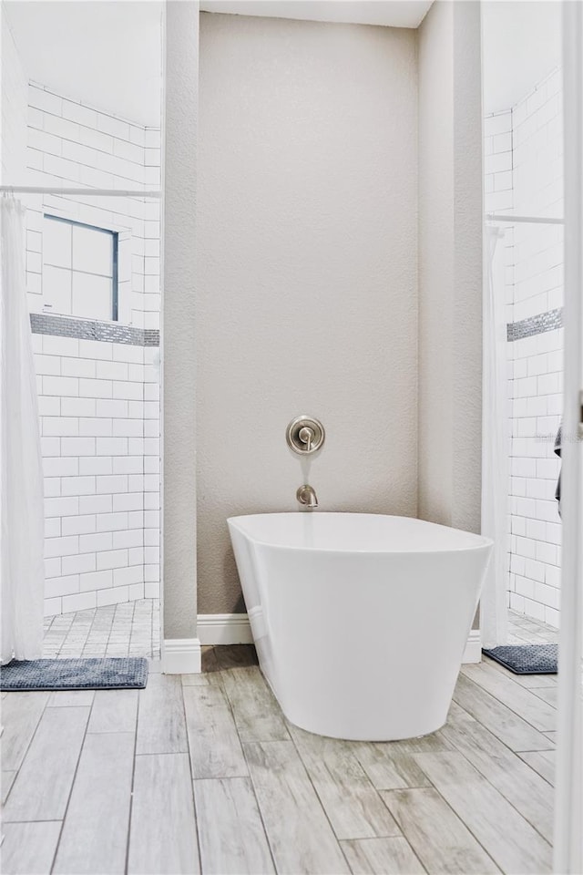 bathroom featuring separate shower and tub