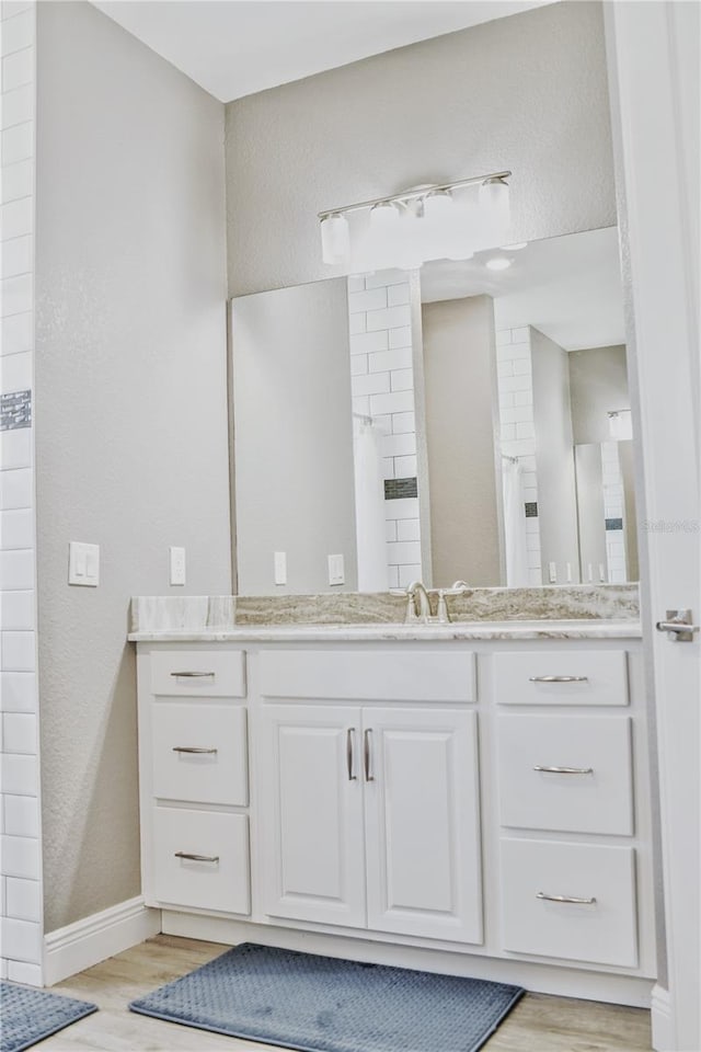 bathroom featuring vanity and hardwood / wood-style floors