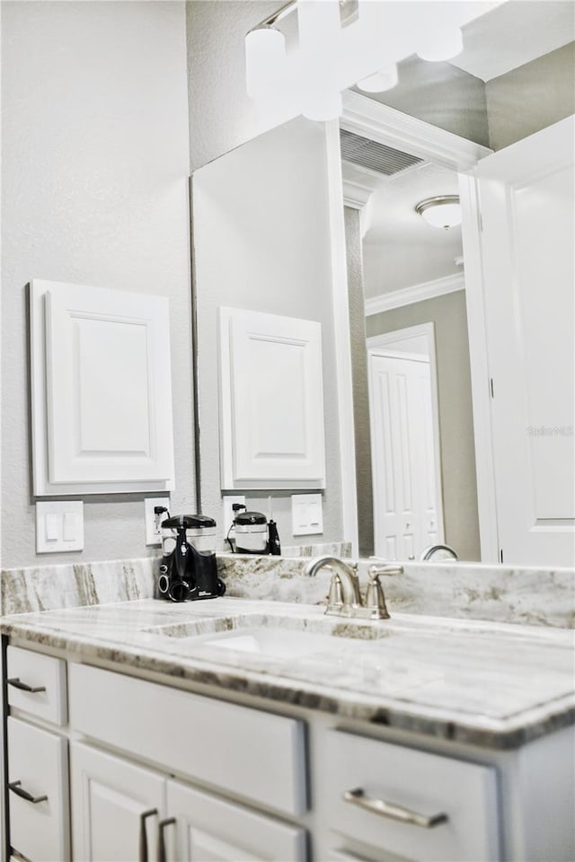 bathroom featuring vanity and crown molding