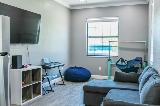 living room with hardwood / wood-style floors and crown molding