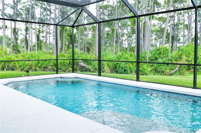 view of swimming pool featuring a lanai