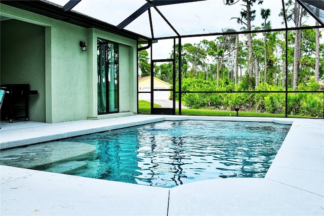 view of pool featuring a patio and glass enclosure