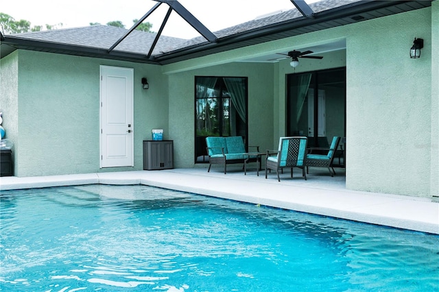 view of pool with ceiling fan, an outdoor hangout area, glass enclosure, and a patio