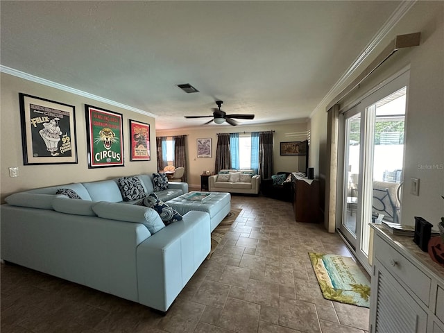 living room with ceiling fan, plenty of natural light, and crown molding