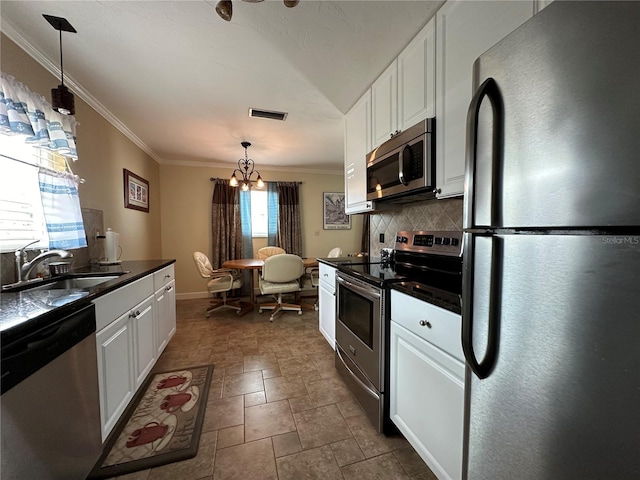 kitchen featuring backsplash, stainless steel appliances, white cabinetry, and a healthy amount of sunlight