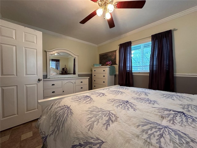 bedroom with ceiling fan and ornamental molding