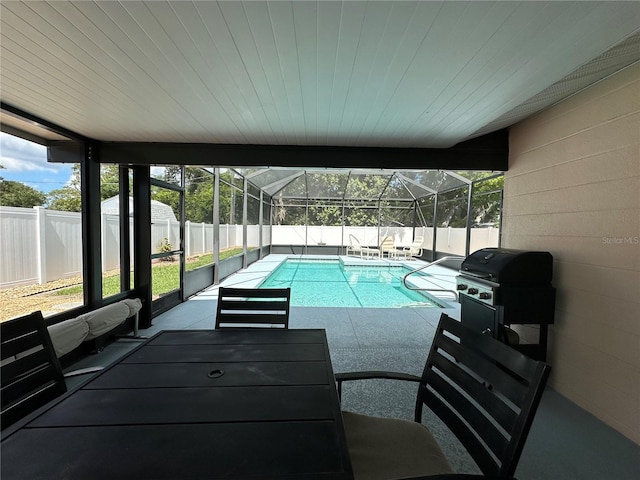 view of pool featuring a lanai, a grill, and a patio area