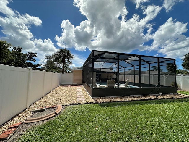 view of yard featuring glass enclosure