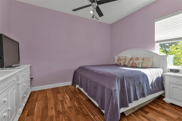 bedroom with ceiling fan and dark wood-type flooring