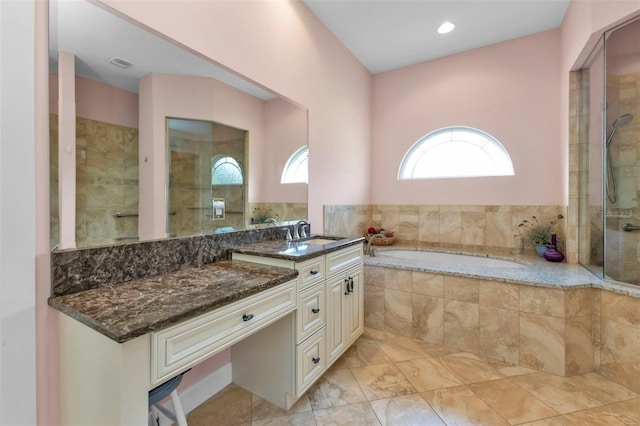 bathroom with vanity and separate shower and tub