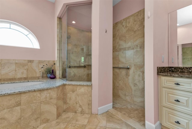 bathroom featuring tiled shower and vanity