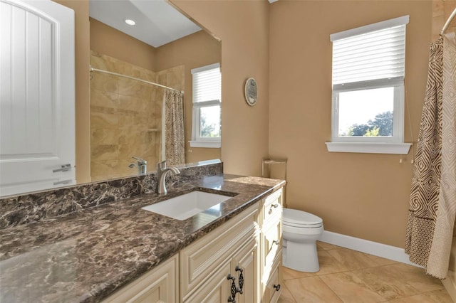 bathroom with tile patterned floors, vanity, toilet, and walk in shower