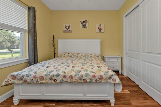 bedroom featuring dark hardwood / wood-style floors and a closet