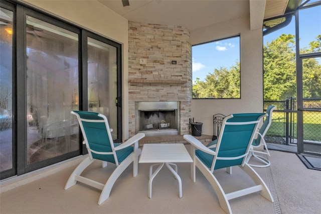 sunroom with an outdoor fireplace