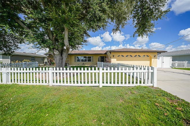 ranch-style home featuring a front lawn and a garage