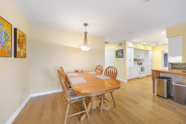 dining space featuring light hardwood / wood-style flooring and ceiling fan