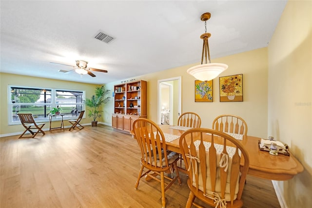 dining room featuring light hardwood / wood-style floors and ceiling fan