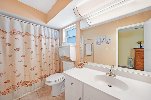 bathroom featuring toilet, vanity, tile patterned floors, and walk in shower