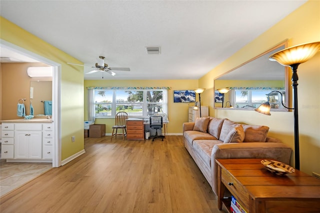 living room featuring ceiling fan and light wood-type flooring