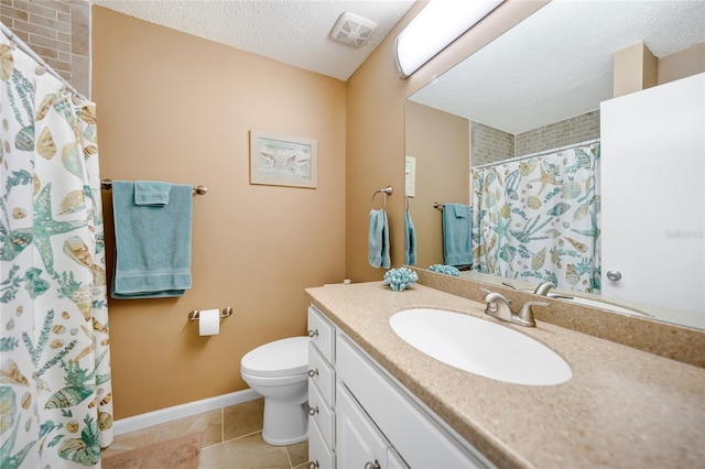 bathroom with vanity, toilet, tile patterned flooring, and a textured ceiling