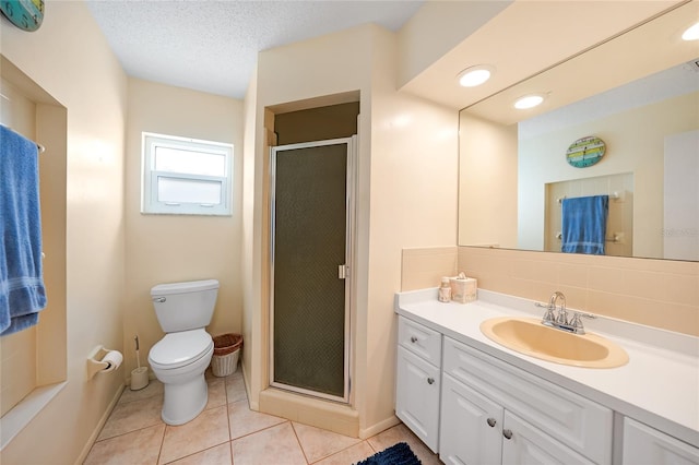 bathroom featuring tile patterned floors, walk in shower, vanity, a textured ceiling, and toilet