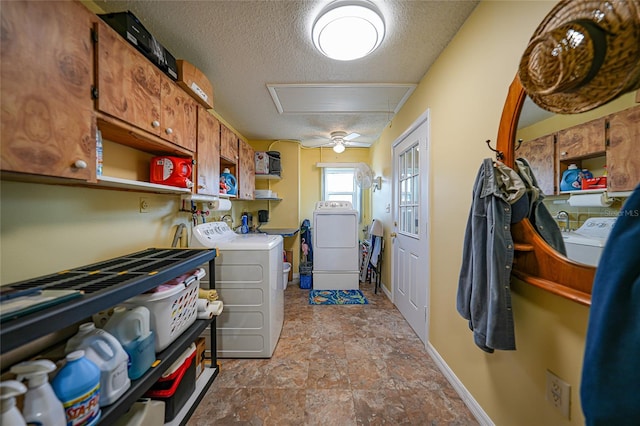 laundry room with washer and clothes dryer and a textured ceiling