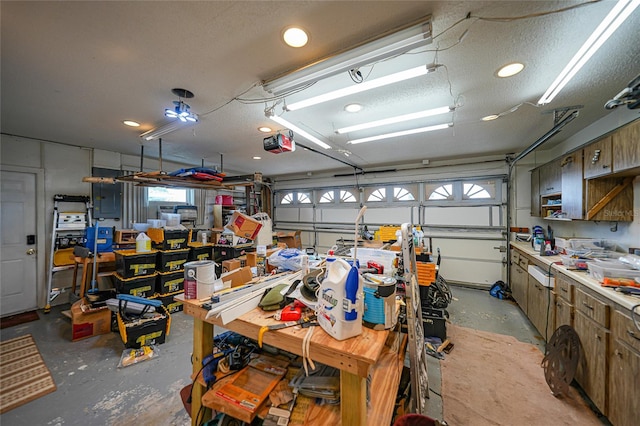 garage featuring a workshop area, electric panel, and a garage door opener