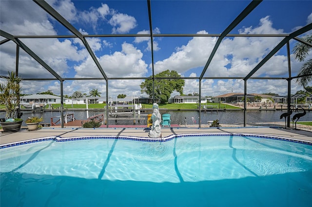 view of swimming pool featuring a dock, a water view, a patio, and a lanai