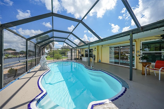 view of swimming pool with a water view, glass enclosure, and a patio area