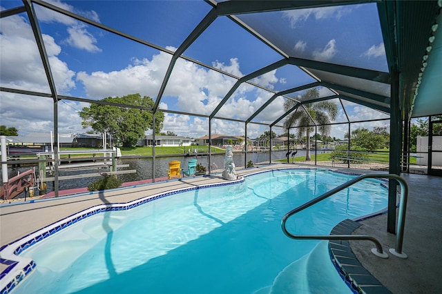 view of pool with glass enclosure, a water view, a patio, and a boat dock