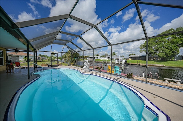 view of swimming pool featuring a lanai, a water view, a patio, and a boat dock