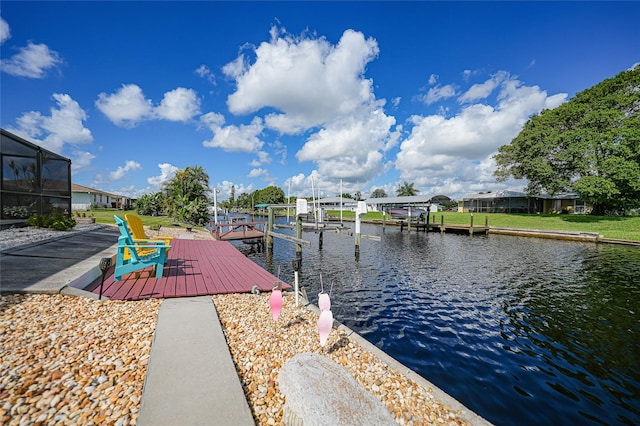 view of dock with glass enclosure and a water view