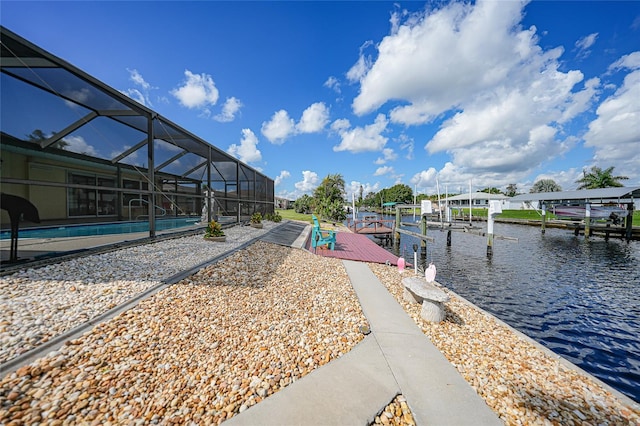 view of property's community with a water view and a boat dock