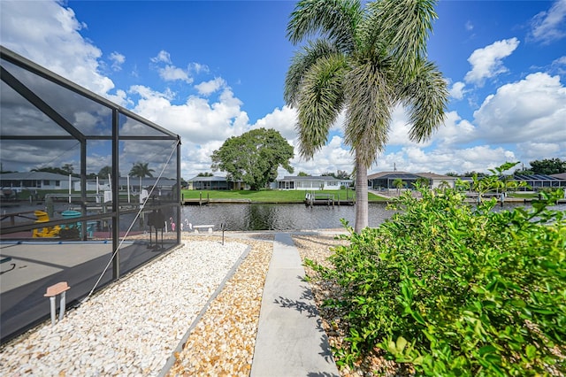 exterior space with glass enclosure and a water view